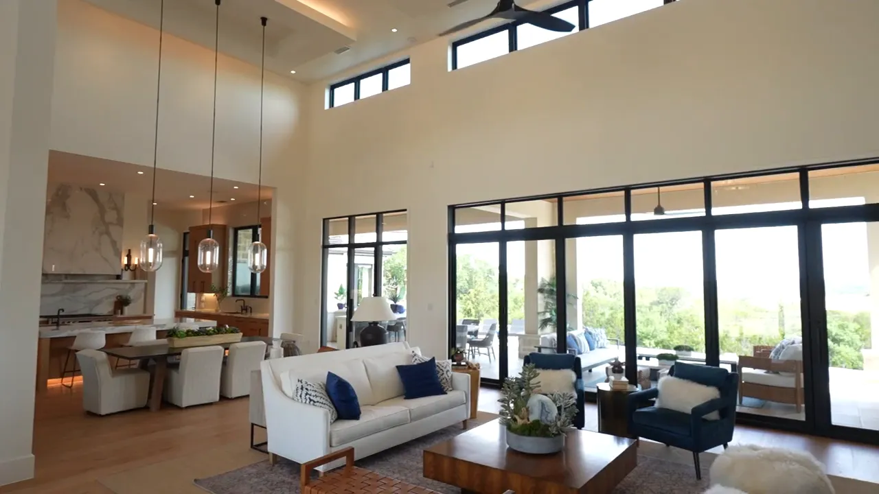 Open living room with tall ceilings fireplace and sliding glass doors
