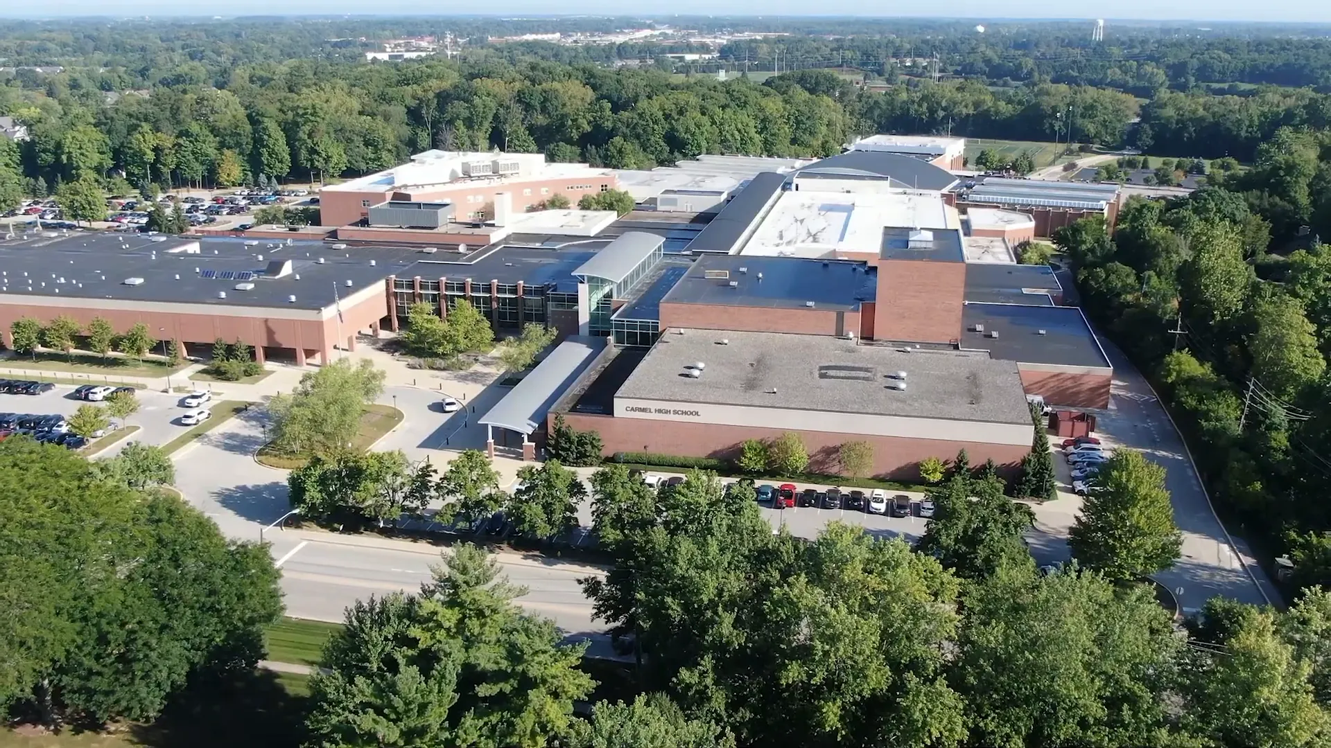Entrance of Carmel High School with students walking