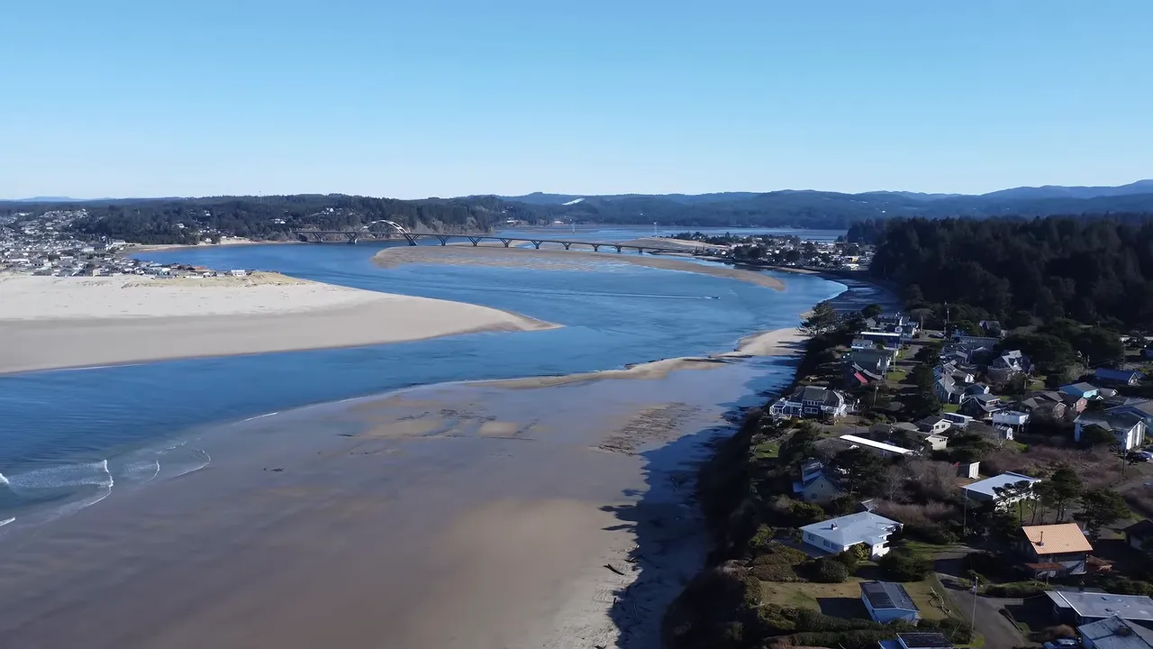 Aerial view of Waldport beside Alsea Bay and sandy shoreline