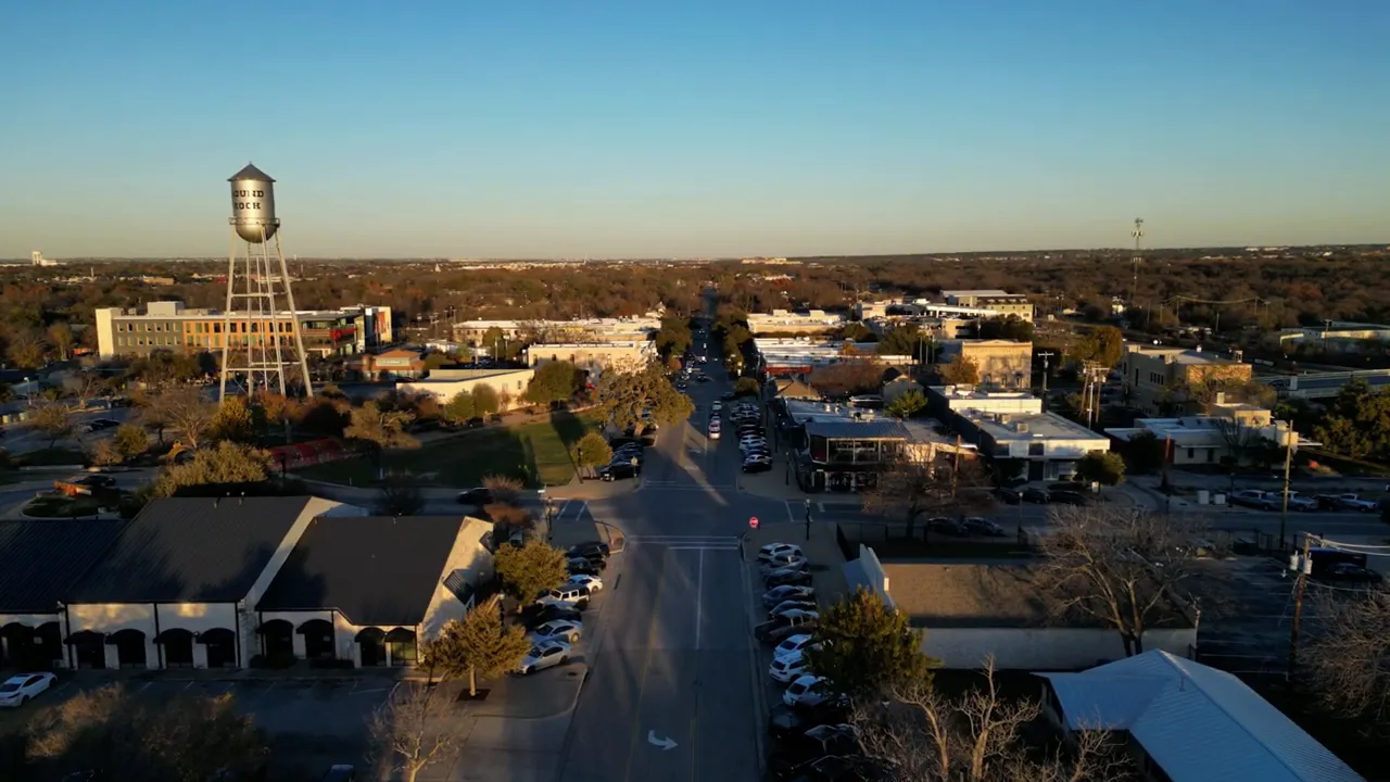Aerial view looking down a Georgetown TX road with shops and traffic