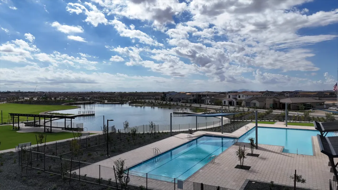 Community pools beside lake and green lawn