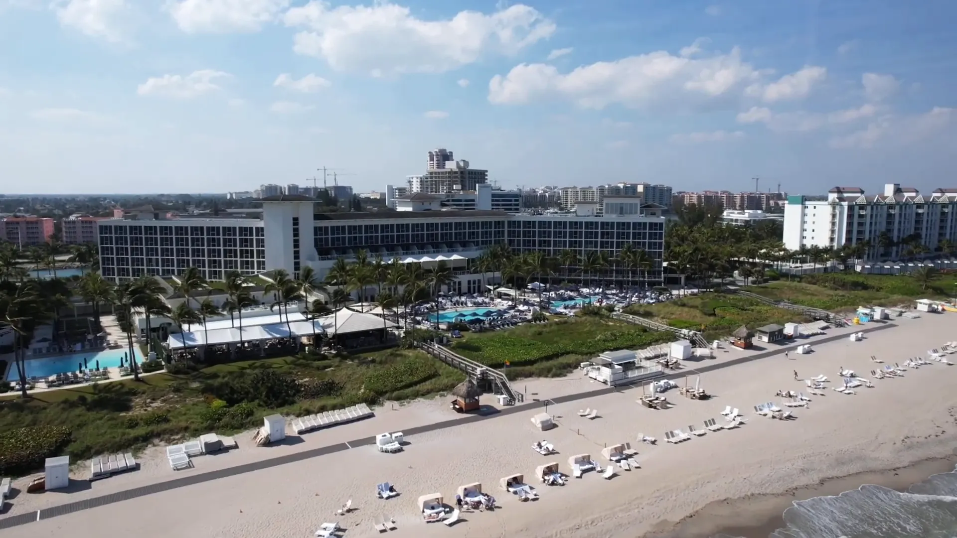 Beach Club cabanas and beachfront seating with ocean in background