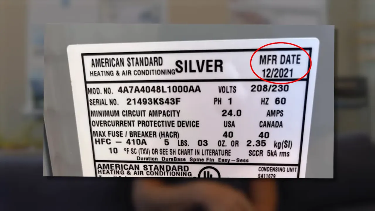 Close-up of HVAC rating plate with MFR date circled and legible