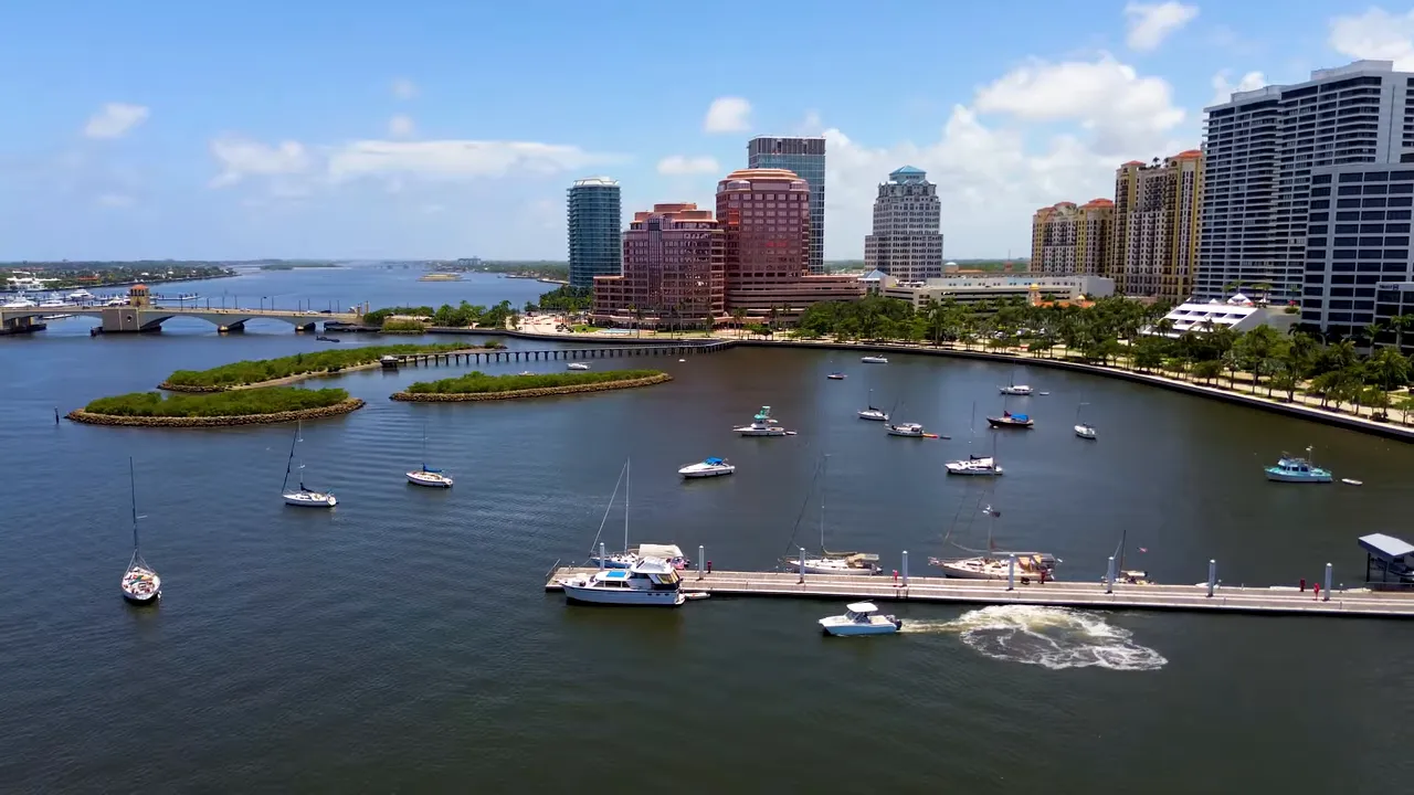 Aerial view of West Palm Beach marina and downtown skyline over calm water