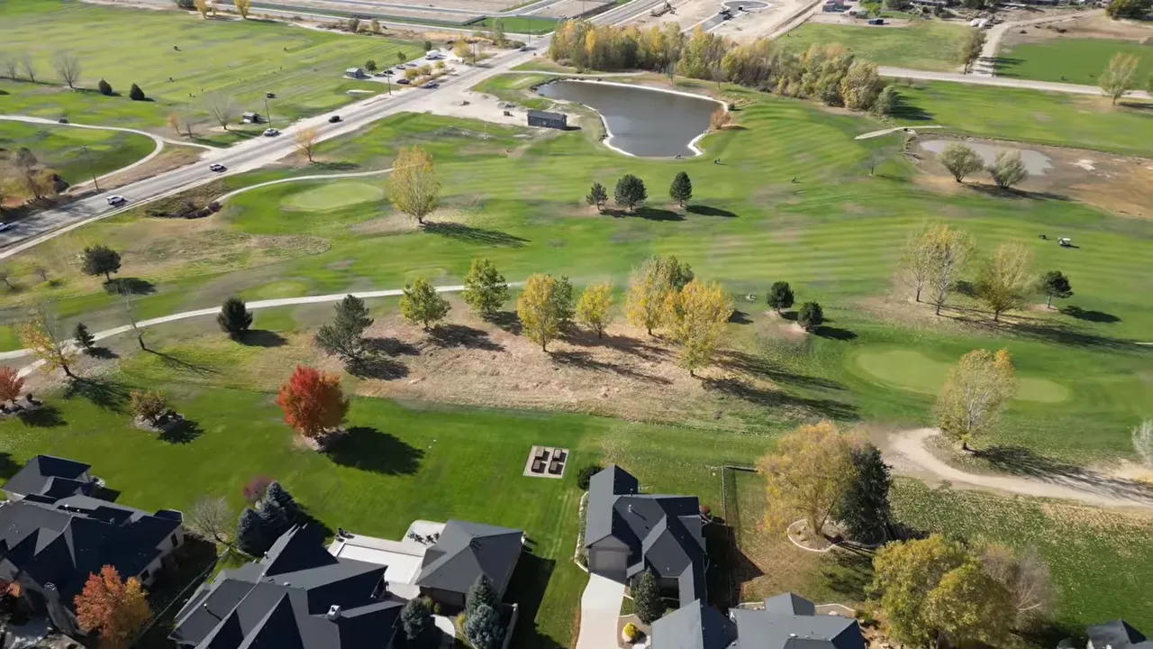 Aerial view of a green golf course with ponds and fairways