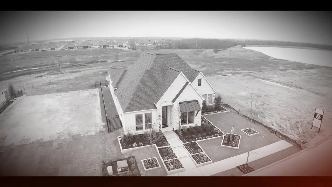 Aerial drone shot of a completed new construction home with landscaping