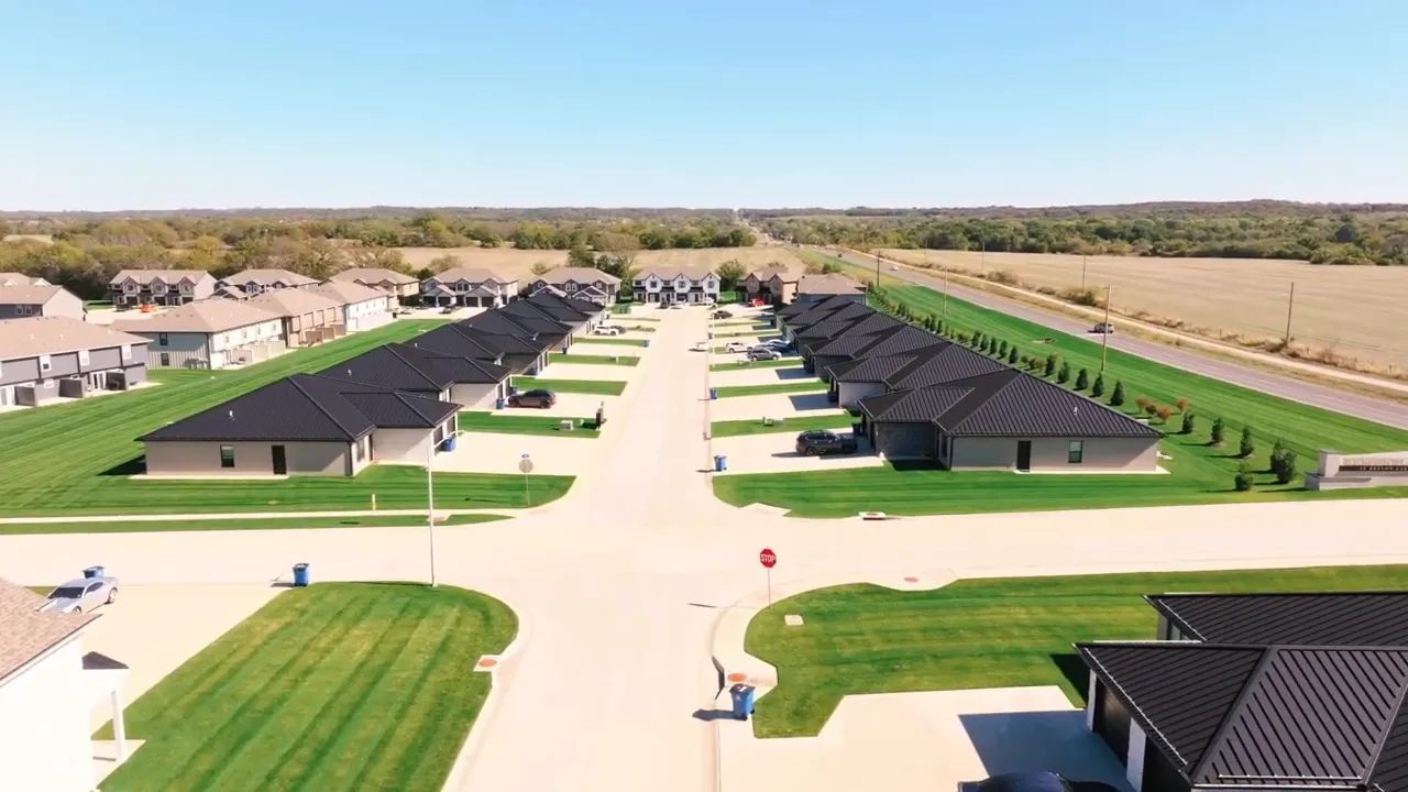 Aerial view of a subdivision with similar newly built homes along wide streets