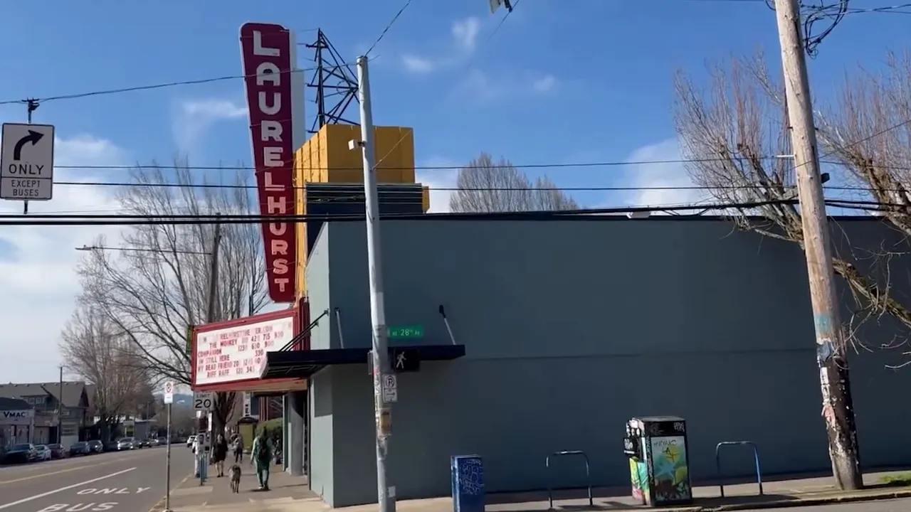 Laurelhurst Theater marquee and vertical theater sign on a street corner