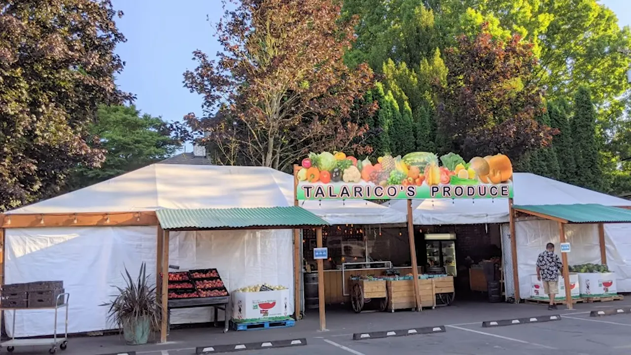 Talaricos Produce market stand with striped awnings and fruit displays