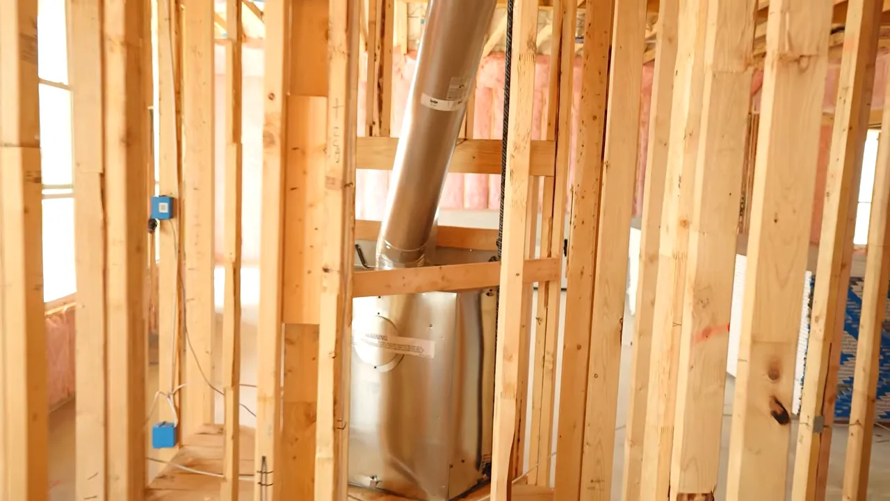 HVAC ductwork and equipment visible in framed interior during pre-drywall