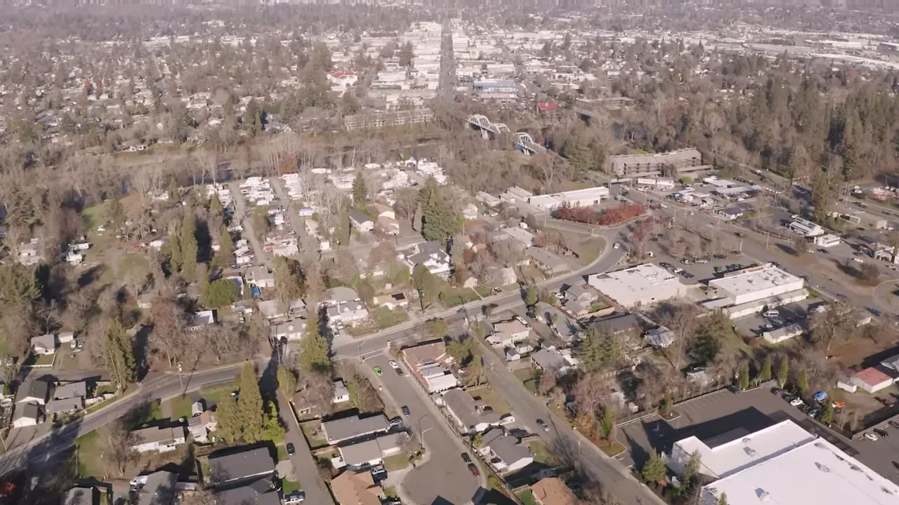 Aerial view of Southern Oregon town streets, housing blocks, and shopping/service area