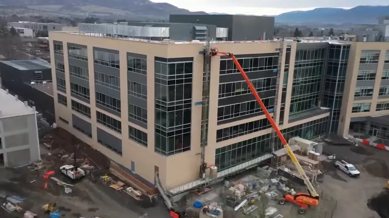 Aerial view of Medford healthcare expansion with cranes and construction equipment at a hospital campus
