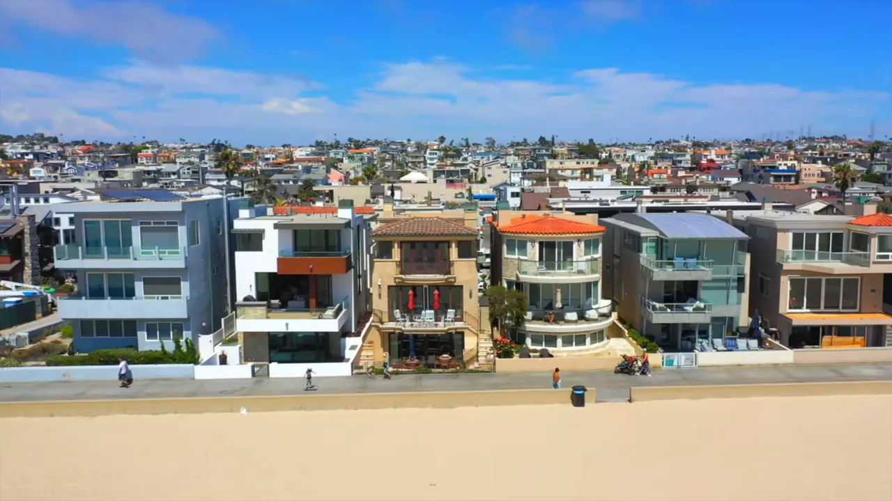 Wide sandy beach with Hermosa Beach pier in the distance