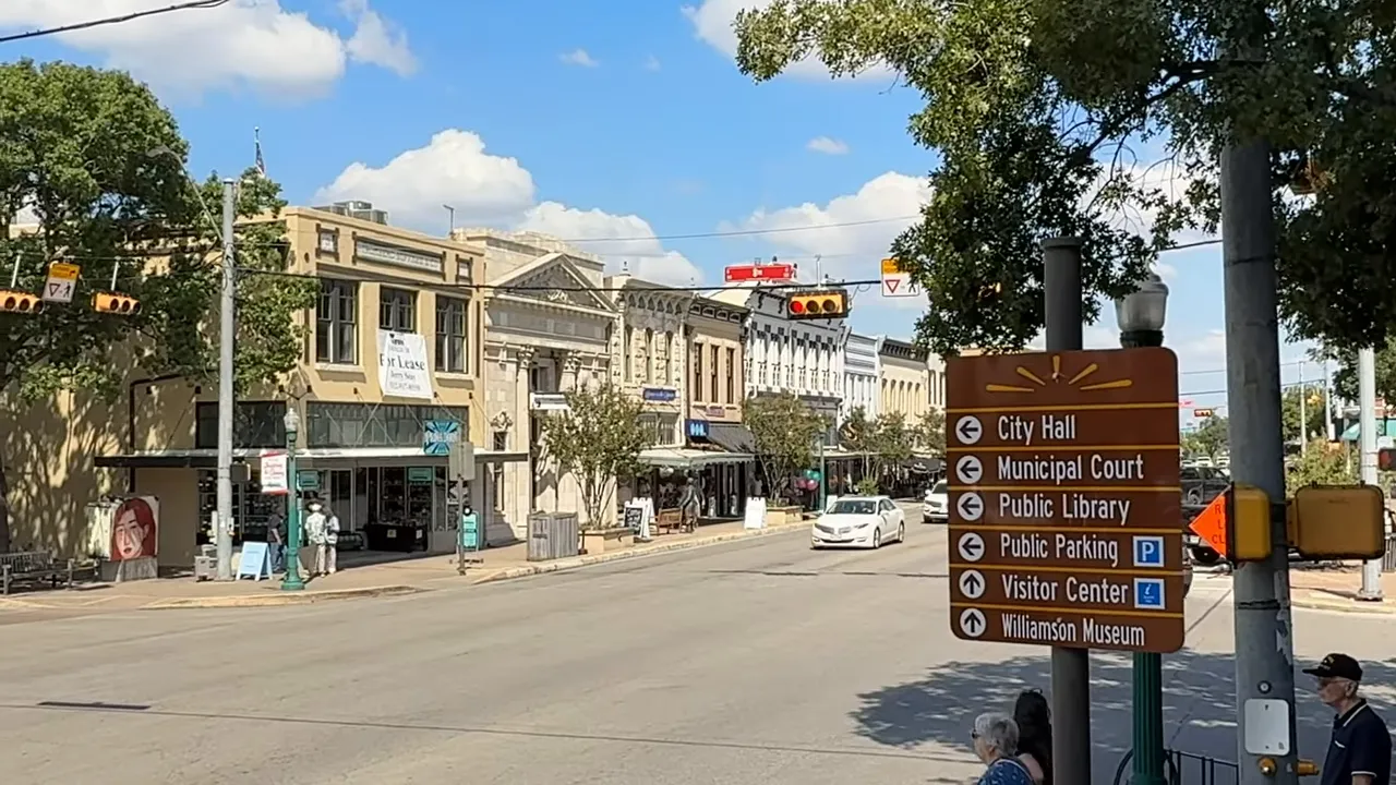 Downtown Georgetown TX street scene with wayfinding sign for City Hall, Municipal Court, and Public Library
