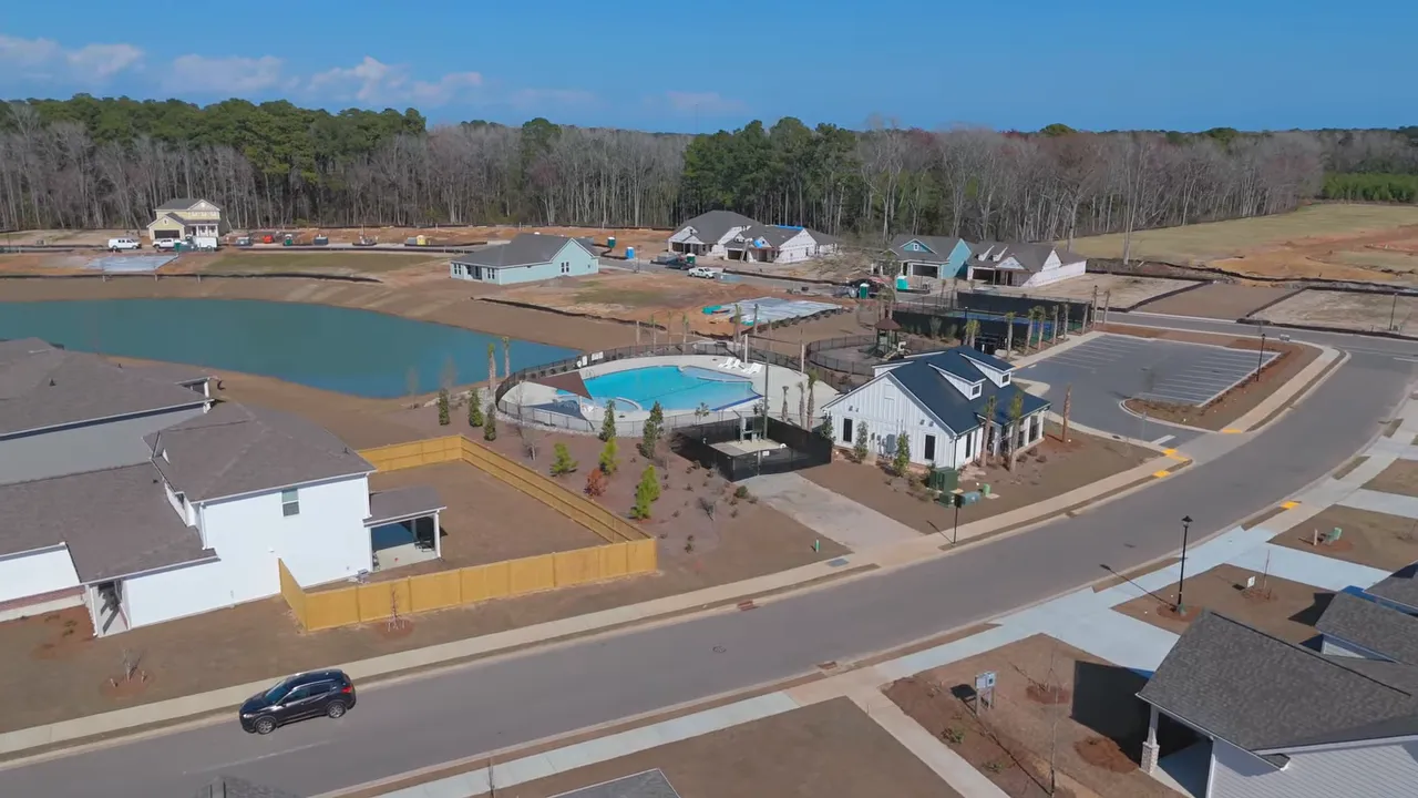 Aerial view of Forestwood by P Y Homes showing the pool and surrounding residential lots