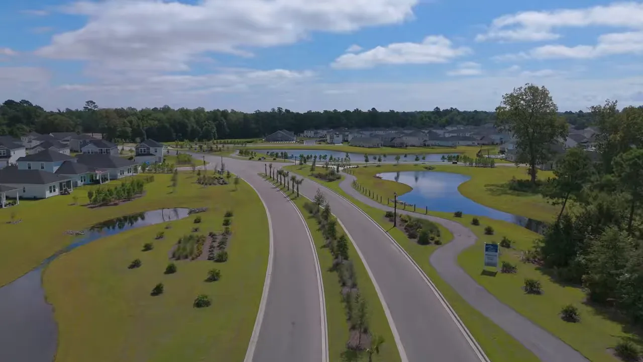 Aerial view of Waterside neighborhood with winding roads, pond area, and homes in the Myrtle Beach South Carolina area