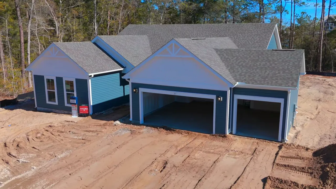 Aerial view of a home with three car garage and wide homesite
