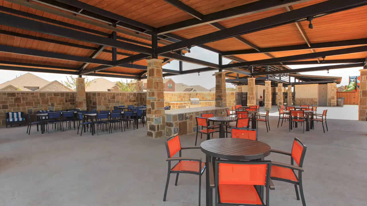 Covered outdoor event space with dining seating at Elevon