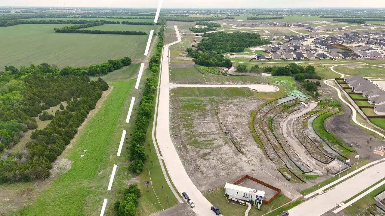 Aerial view of Creekside at Elevon development in Lavon TX with open acreage and planned streets