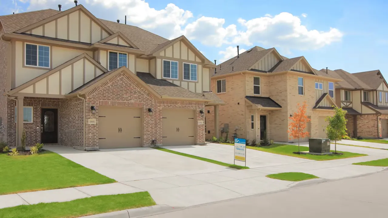 Front yard and driveway of a Grand Home at Creekside at Elevon in Lavon TX