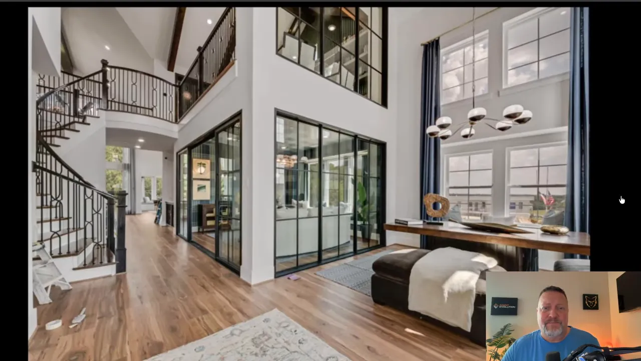 Grand Homes two-story entry and living area with glass wall and modern staircase in Creekside at Elevon near Lavon TX