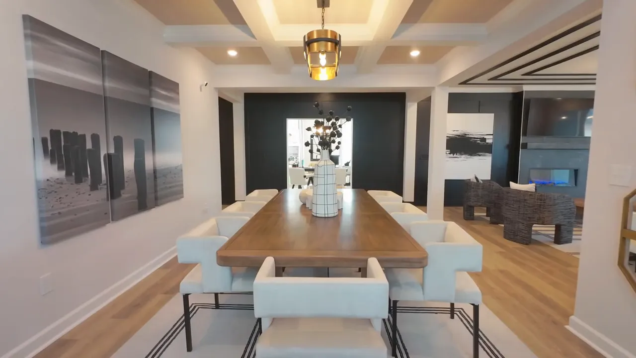 Model style formal dining room with long table and decorative ceiling treatment