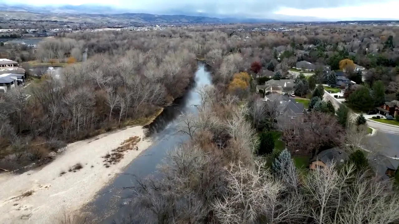 Aerial view of the Boise River winding through neighborhoods and trees