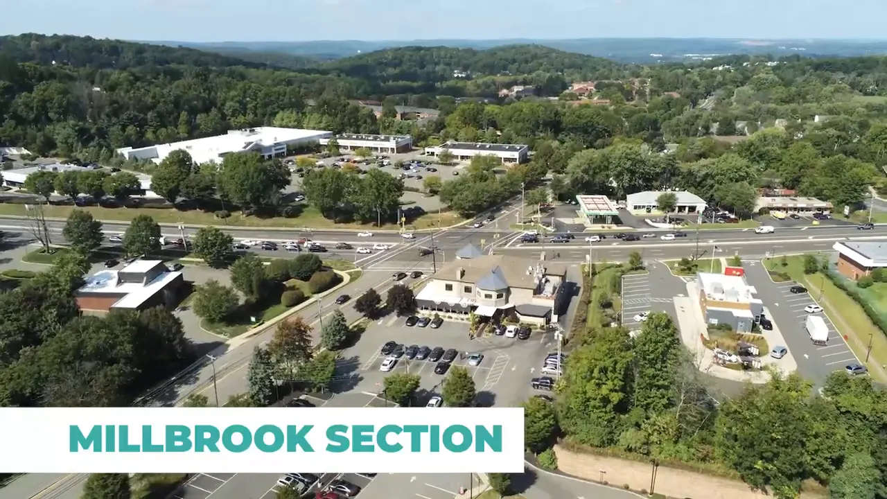 Aerial view of Route 10 intersection with commercial buildings and parking lots in Millbrook section