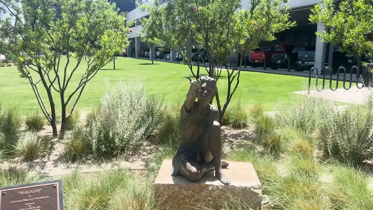 Park with large wood nymph sculptures in downtown Lubbock