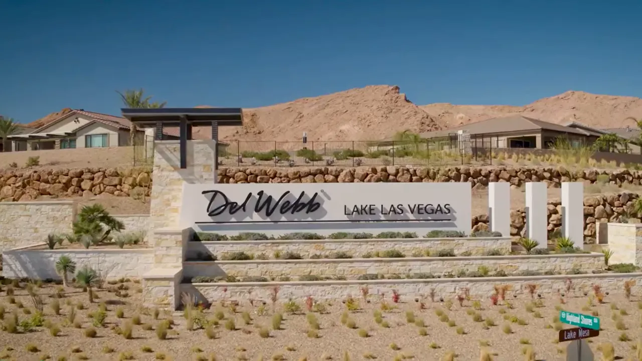 Entrance sign for Del Webb Lake Las Vegas with desert hills behind it