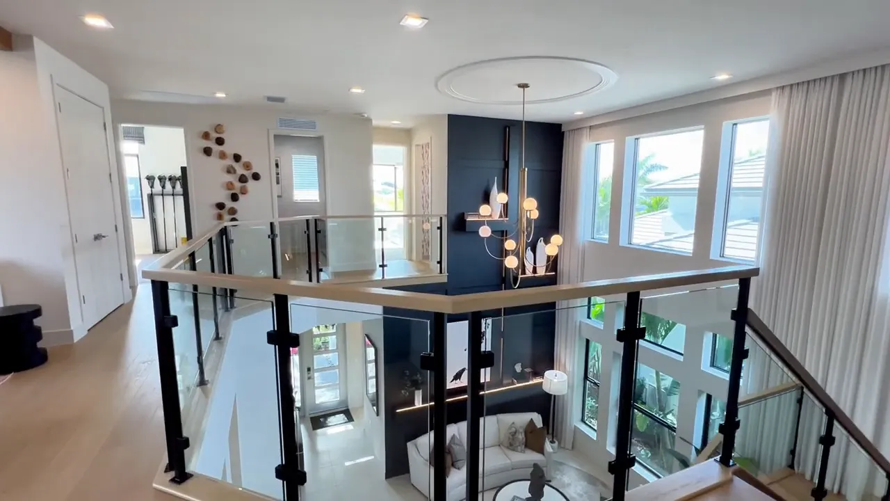 Two-story entry lobby and gallery-style transition view in the Polaris model home at Avenir Palm Beach Gardens
