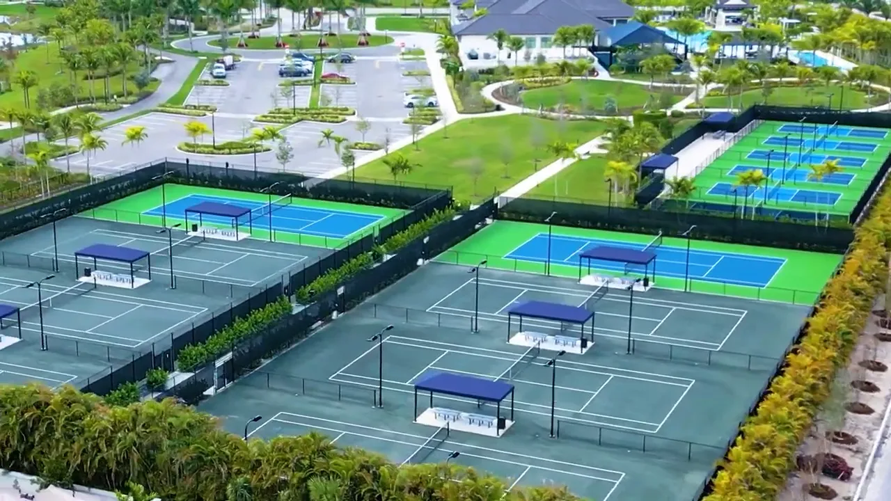 Aerial view of tennis and pickleball courts and outdoor recreation facilities at Avenir Palm Beach Gardens