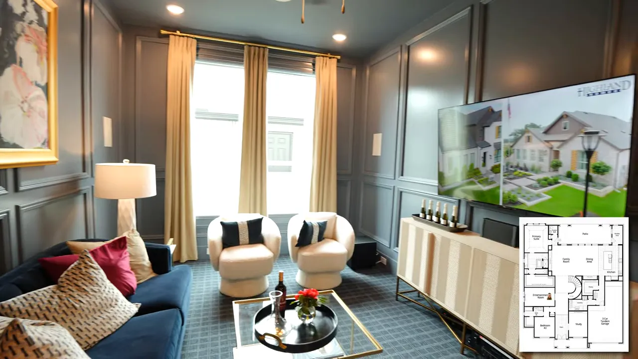Downstairs media room with dark paneled walls sofa chairs and television