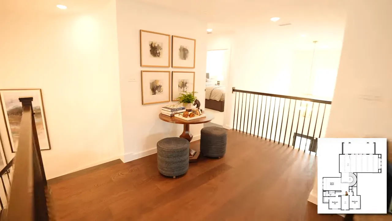 Upstairs landing with round table stools and railing overlooking below
