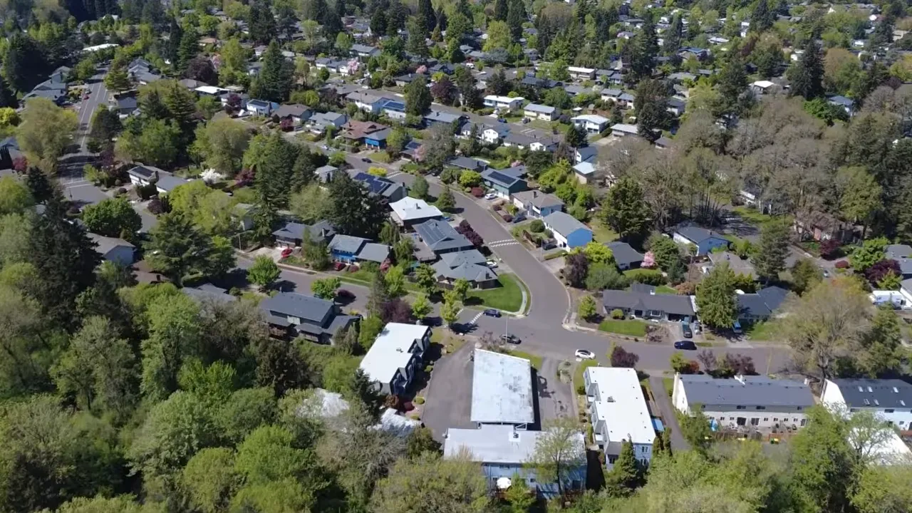 Aerial estate neighborhood view with on screen text stating most homes buyers want sit well above 600000 dollars