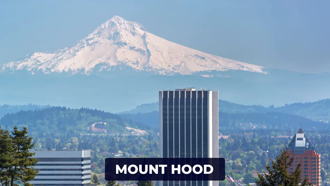 Snow covered Mount Hood rising behind downtown buildings with a Mount Hood label on screen