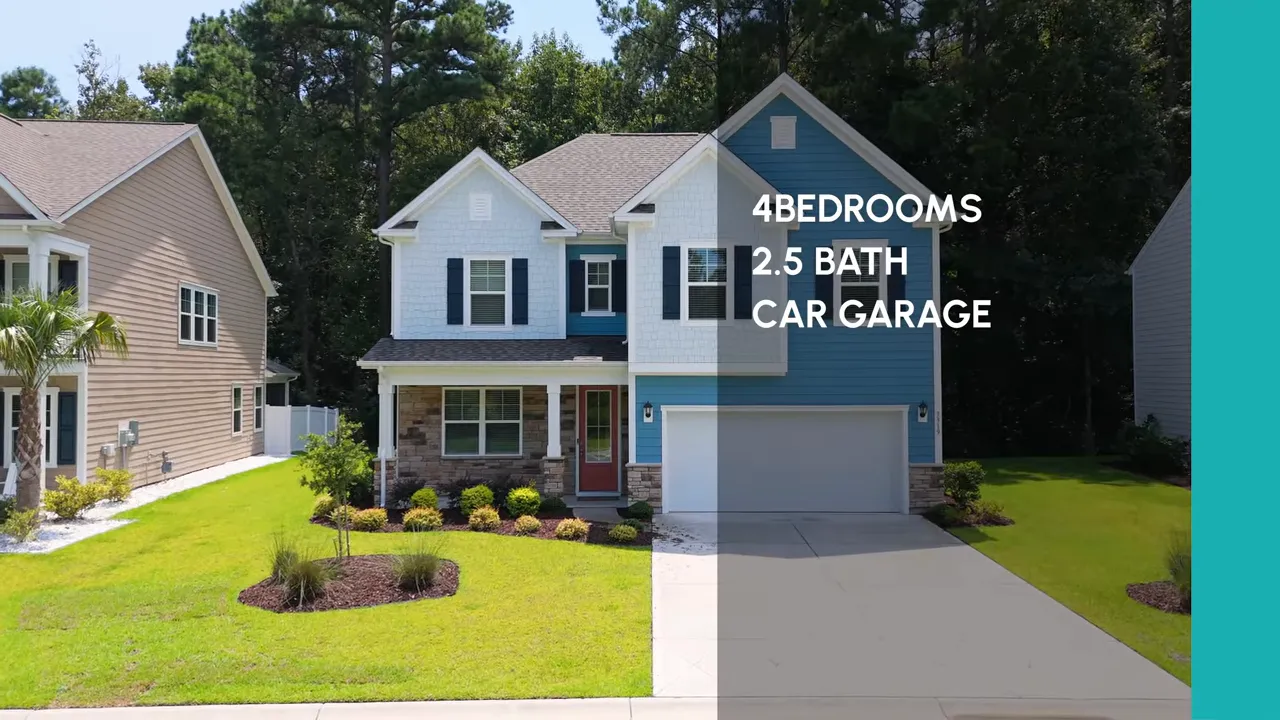 Blue two story home with driveway and landscaped front yard