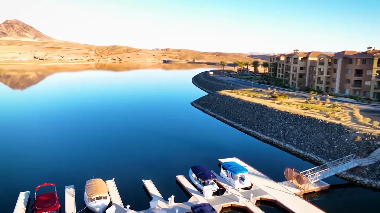 Boats docked at a marina on the calm blue Lake Las Vegas shoreline