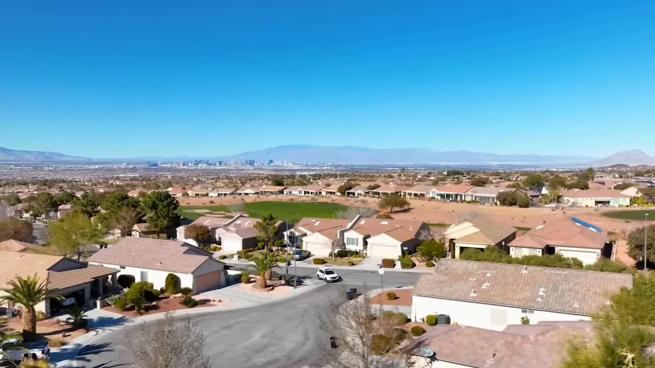 Homes on an elevated hillside overlooking the Las Vegas valley and mountains