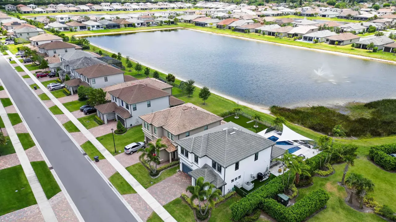 Aerial view of homes and lake within The Fields community in West Lake Worth, Florida