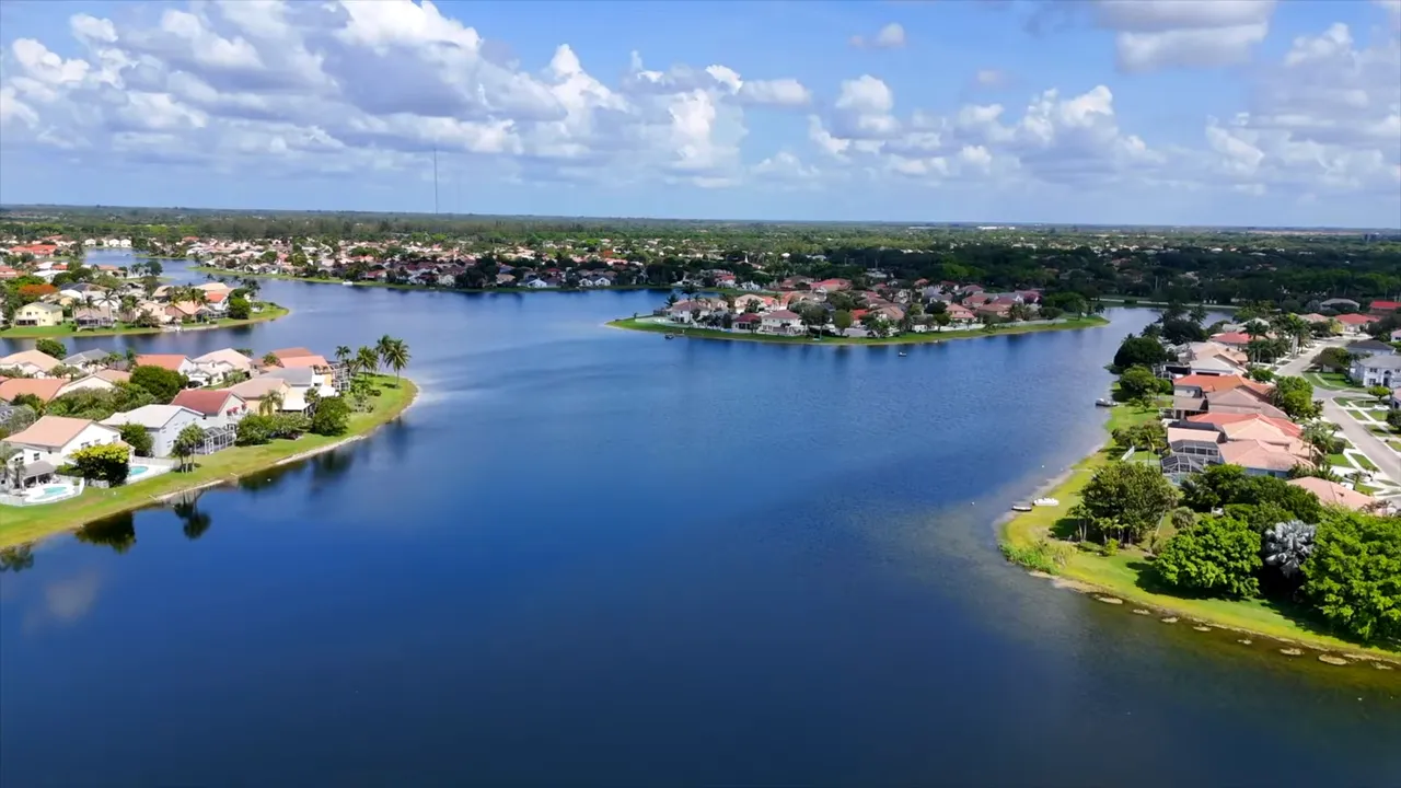 Aerial view of Lake Charleston lake in West Lake Worth Florida with waterfront homes and streets