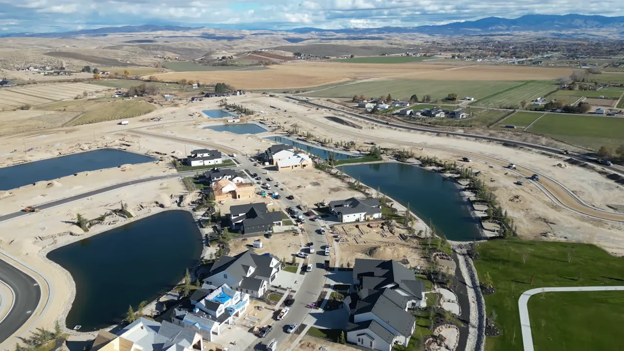 Aerial view of Terra View neighborhood in Eagle, Idaho showing multiple lakes, new construction homes, roads and surrounding parkland