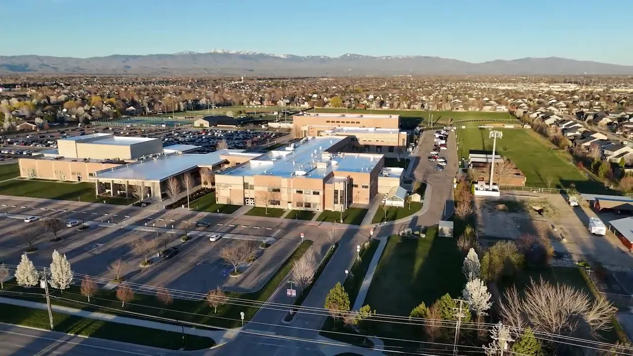 large school campus with parking lots and athletic fields