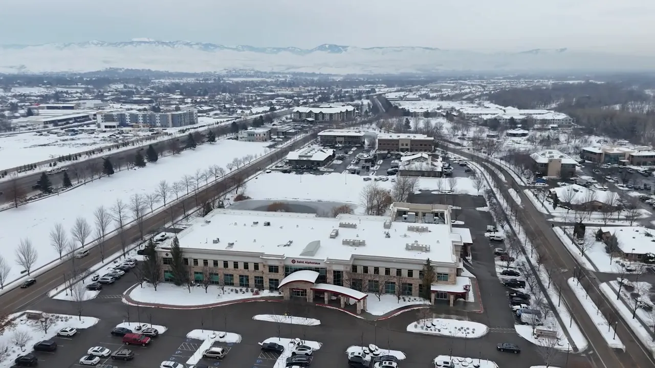 snow covered town streets and buildings seen from above