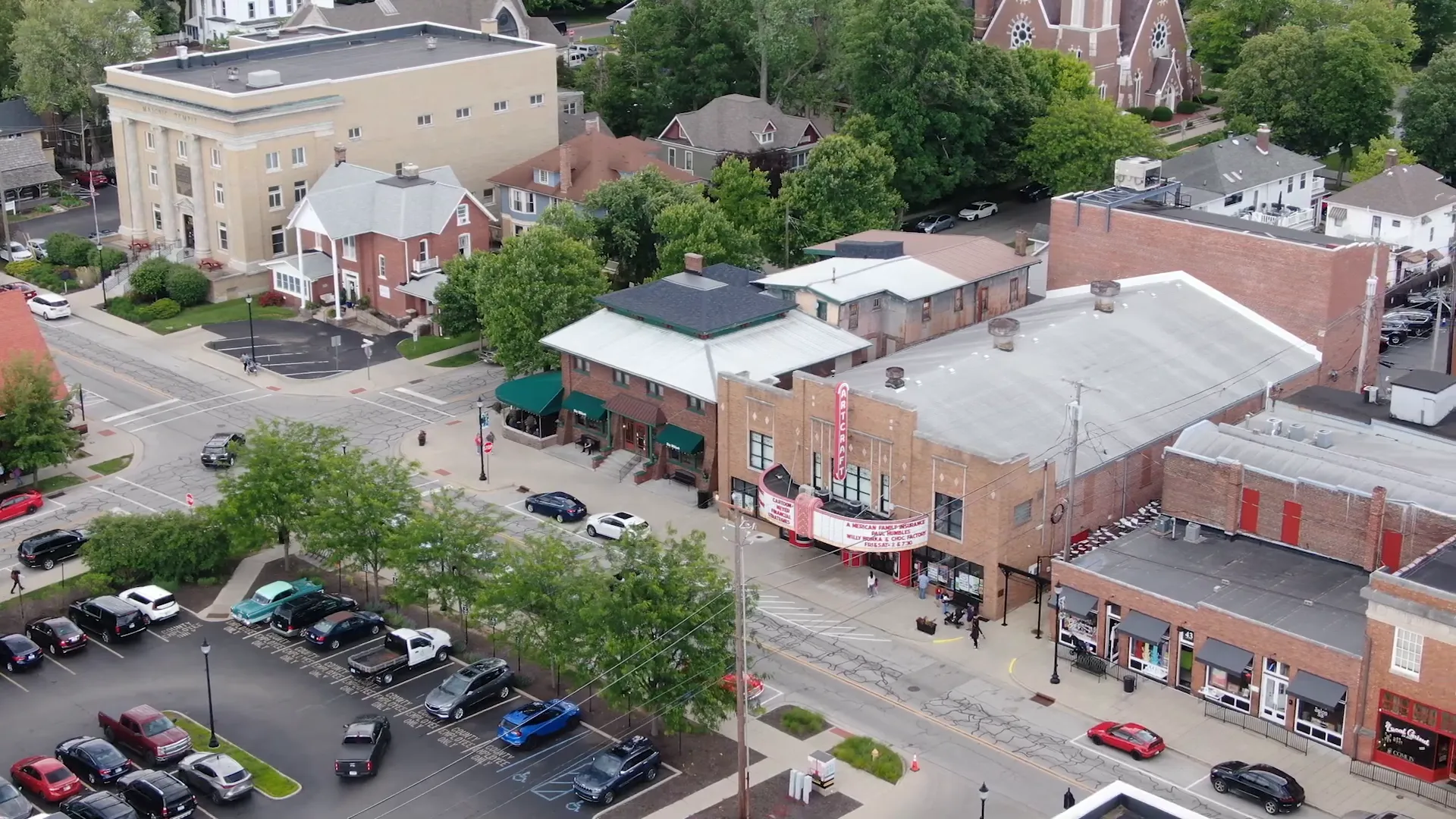 Small downtown storefronts and people browsing local shops