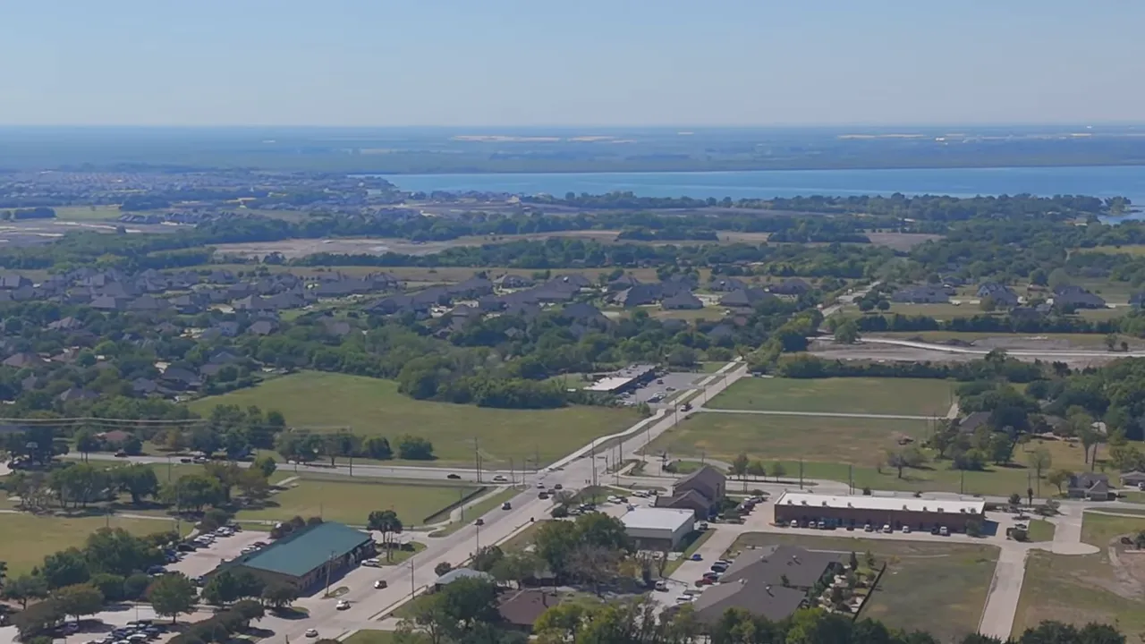 Aerial panorama of Heath neighborhoods with Lake Ray Hubbard on the horizon and nearby roads