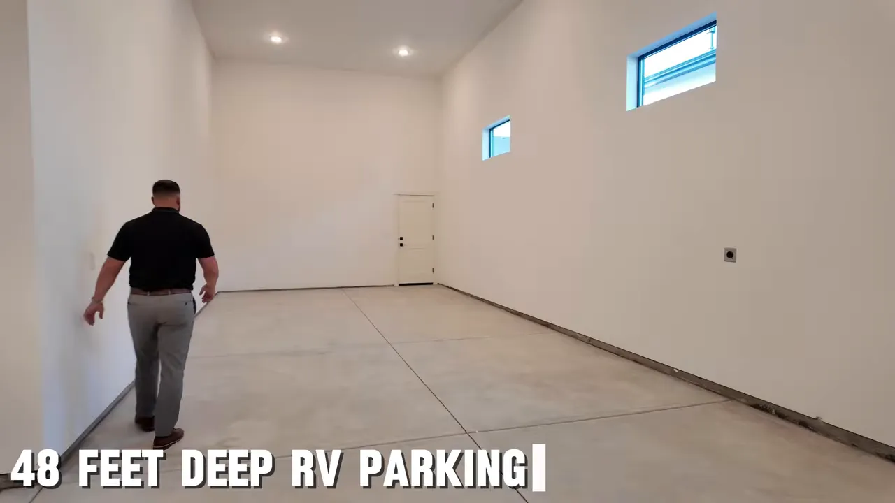 Long empty RV garage bay with high windows and concrete floor