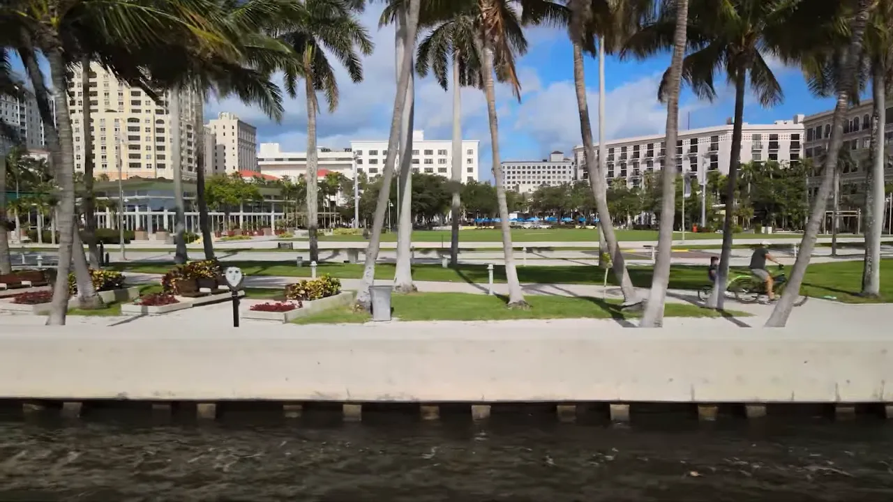 Palm trees and resort buildings near a waterfront in West Palm Beach
