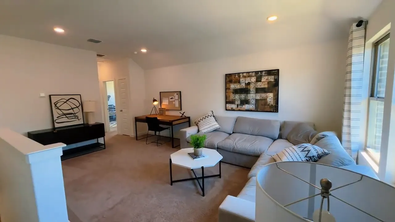 Upstairs game room with sectional sofa desk coffee table and windows