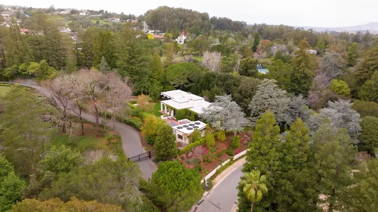 High-angle aerial view of Skyfarm neighborhood showing houses, trees and elevation differences